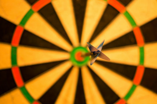 Dart in bullseye. Represents perfection.