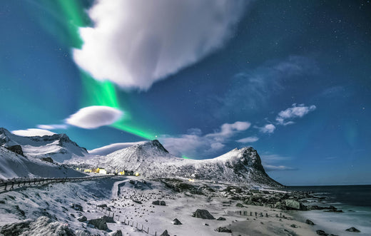 Northern mountain village with auroras borealis