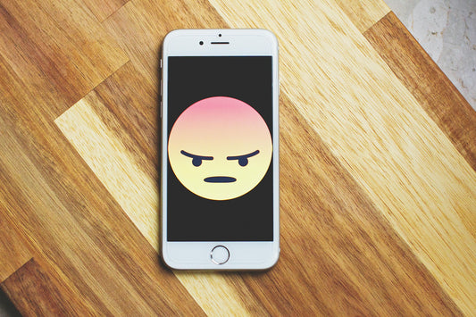 Cell phone with angry emoji