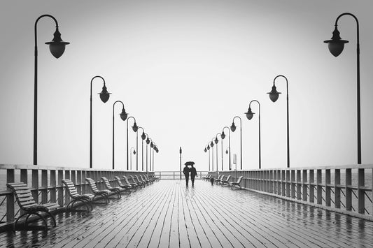 Couple walking on wood bridge in the distance