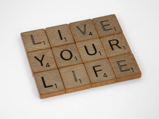 Scrabble letters saying 'Live your life'.
