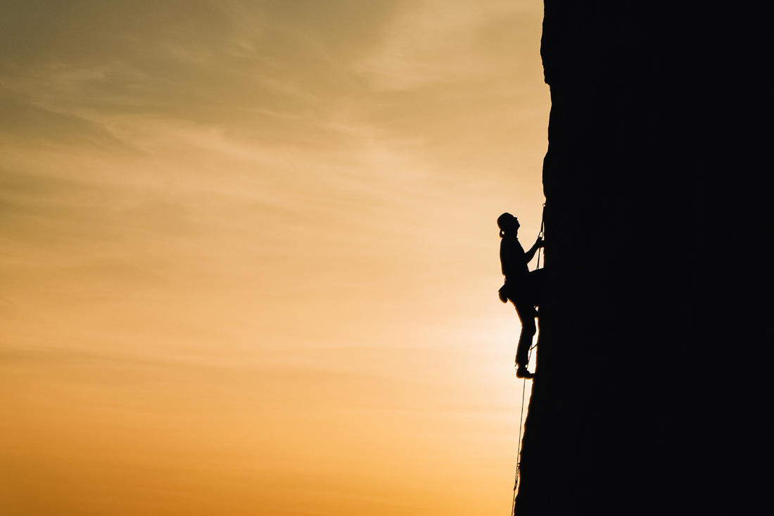 Person climbing cliff