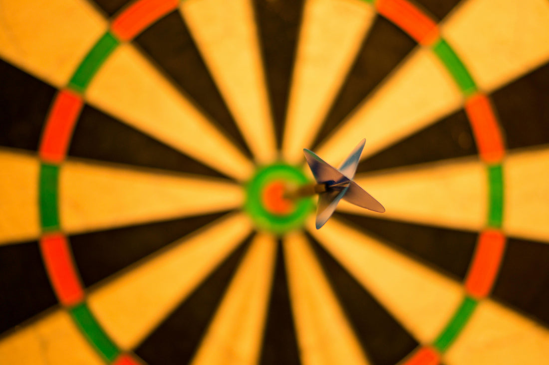 Dart in bullseye. Represents perfection.