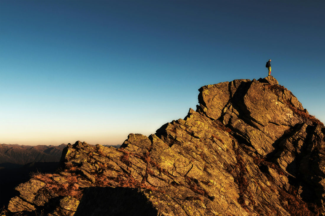 Person at the peak of a mountain looking out