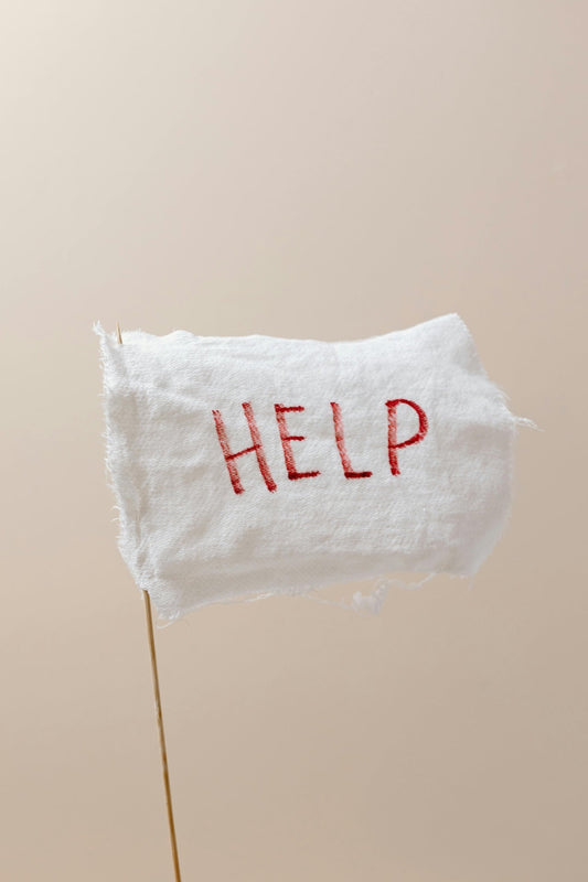 White flag with “Help” written in red. 