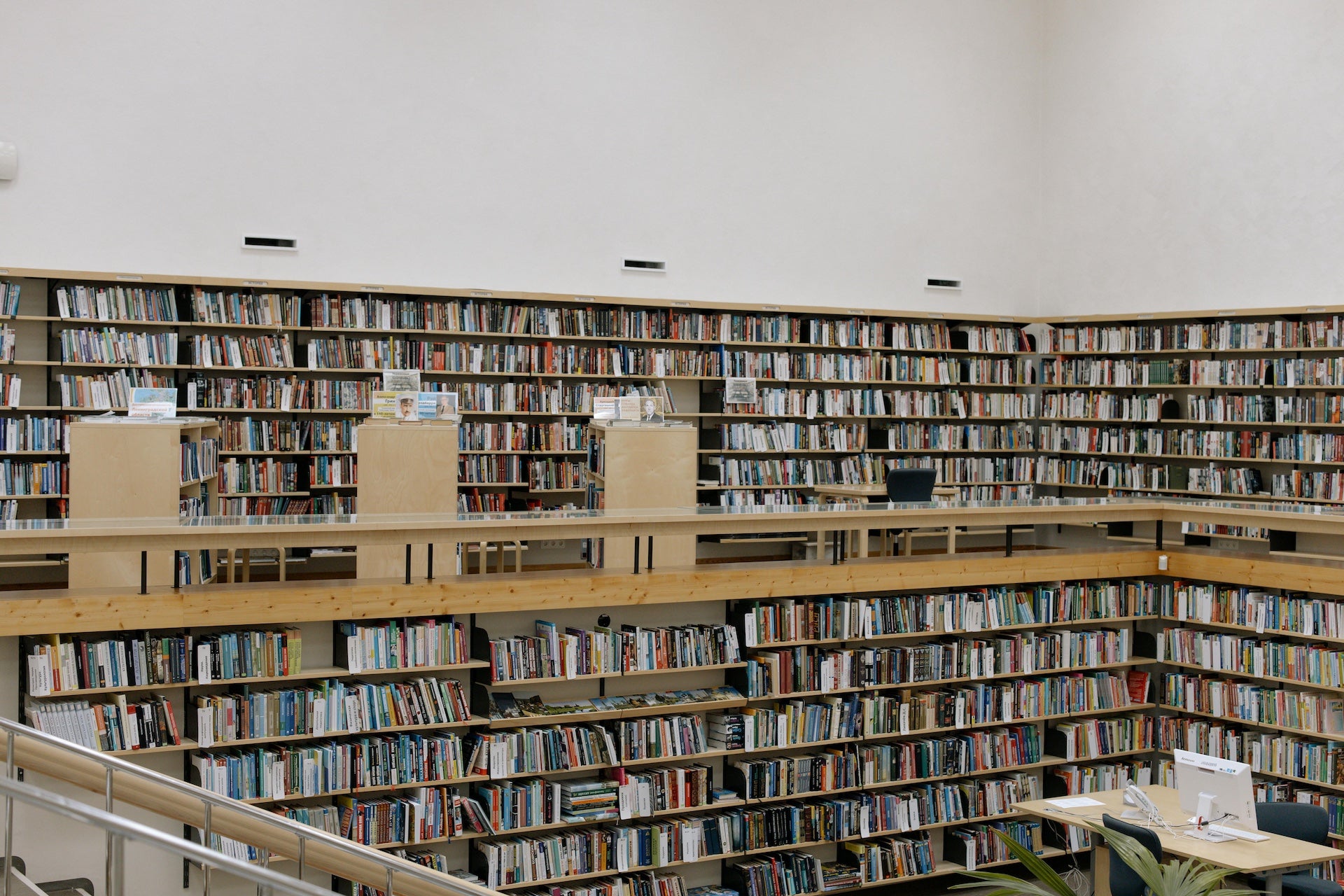 Library with bookshelves filled with books on a white wall background