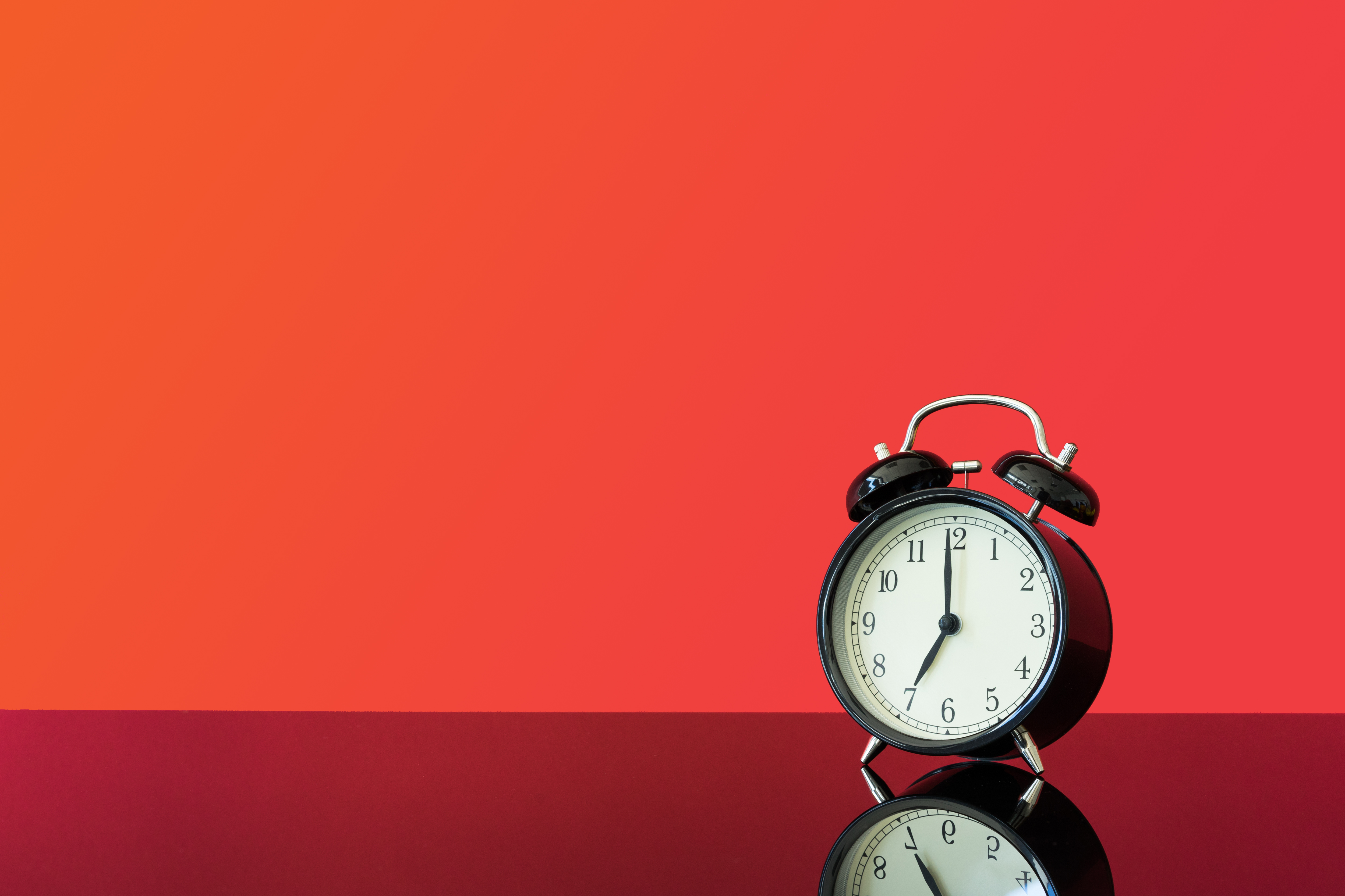 Alarm clock with a red background.